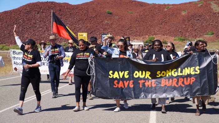 Protesters march near the site of the oil and gas project
