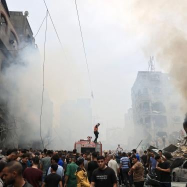 Palestinians search for survivors after an airstrike on buildings in the refugee camp of Jabalia in the Gaza Strip on October 9, 2023. 
